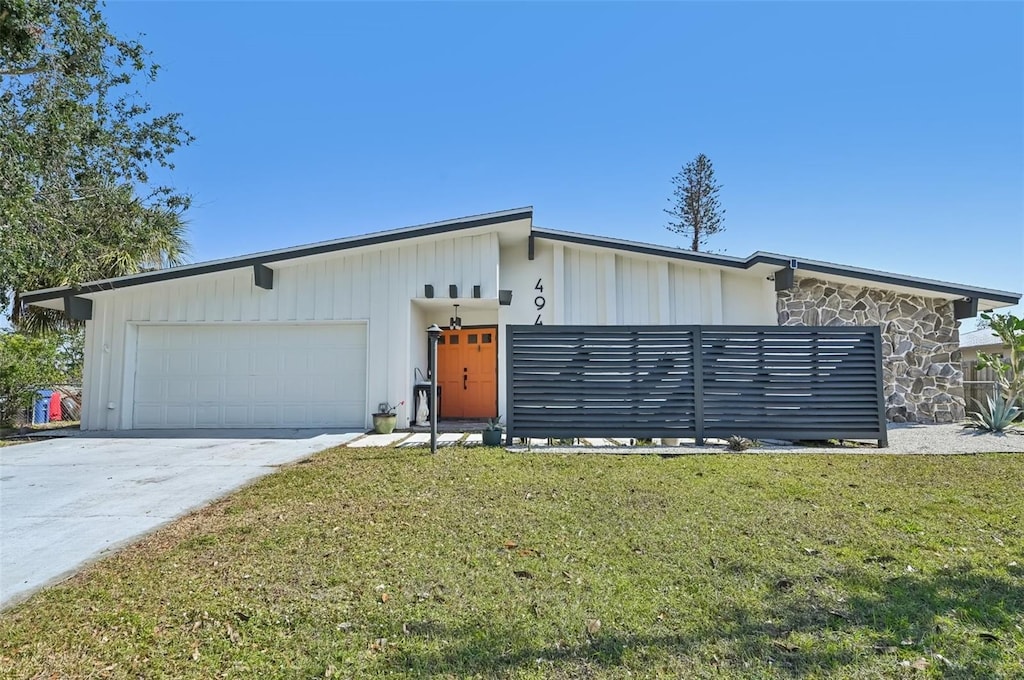 view of front of home featuring a garage and a front lawn