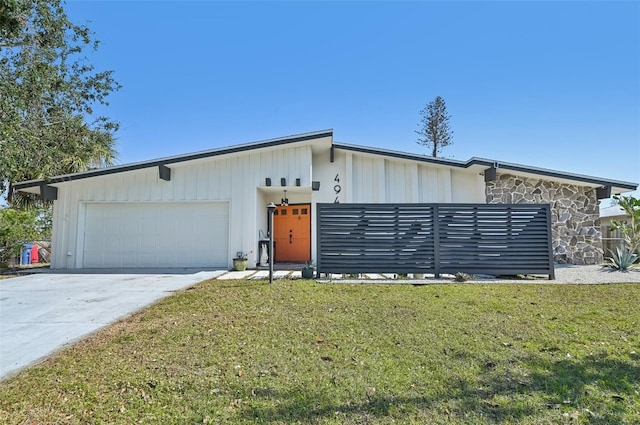 view of front of home featuring a garage and a front lawn