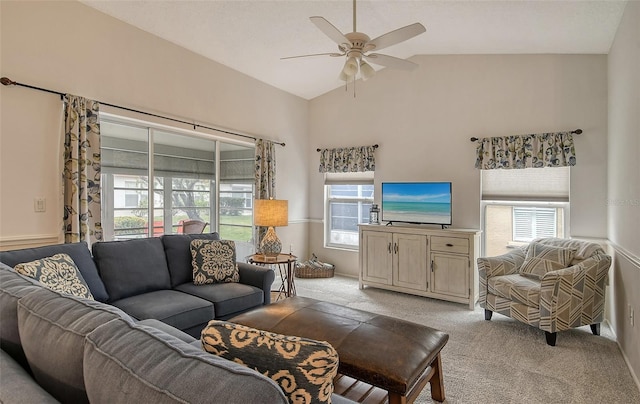 living room featuring ceiling fan, a healthy amount of sunlight, vaulted ceiling, and light carpet