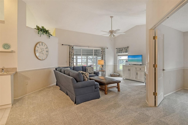 carpeted living room featuring high vaulted ceiling and ceiling fan