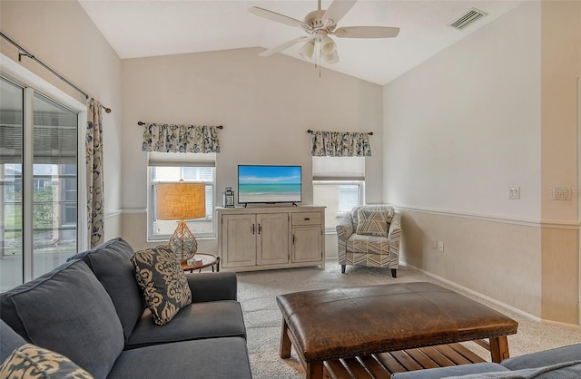 carpeted living room with vaulted ceiling and ceiling fan