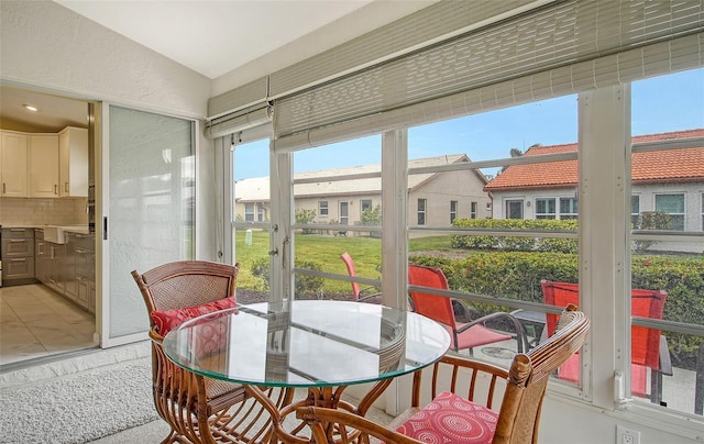 sunroom featuring vaulted ceiling and a wealth of natural light