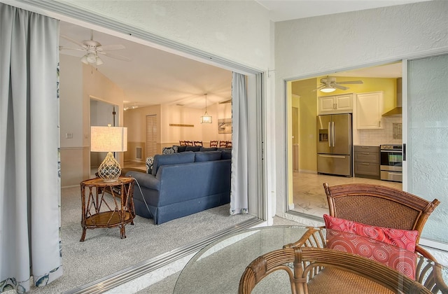 living room with lofted ceiling and ceiling fan