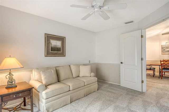 carpeted living room featuring ceiling fan