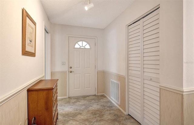 doorway to outside featuring a textured ceiling