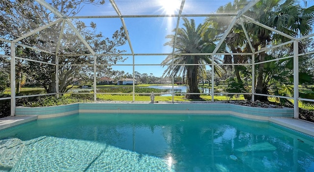 view of pool featuring a water view and glass enclosure