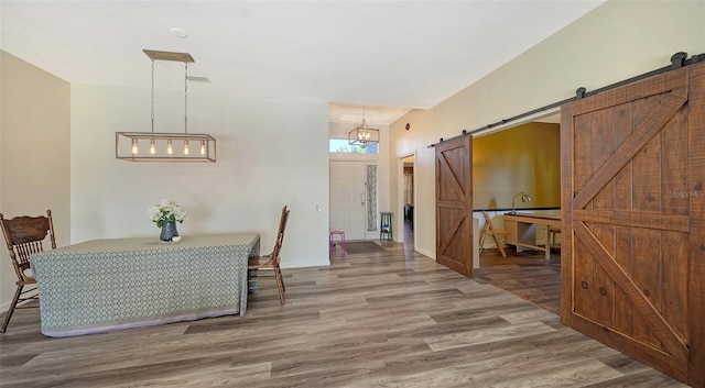 interior space featuring hardwood / wood-style flooring and a barn door