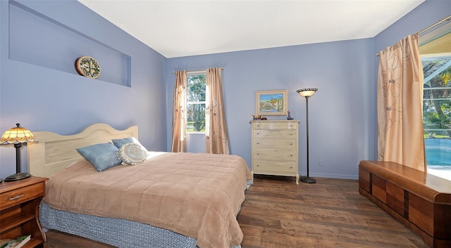 bedroom with dark hardwood / wood-style flooring