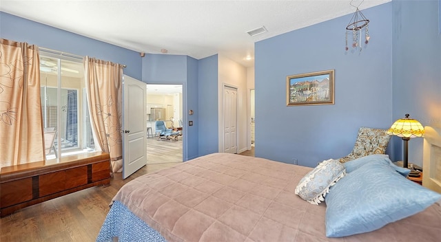 bedroom with hardwood / wood-style floors and a closet