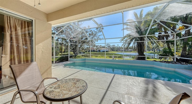 view of swimming pool with a lanai and a patio area