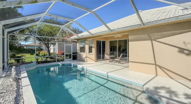 view of pool with ceiling fan, a lanai, and a patio area