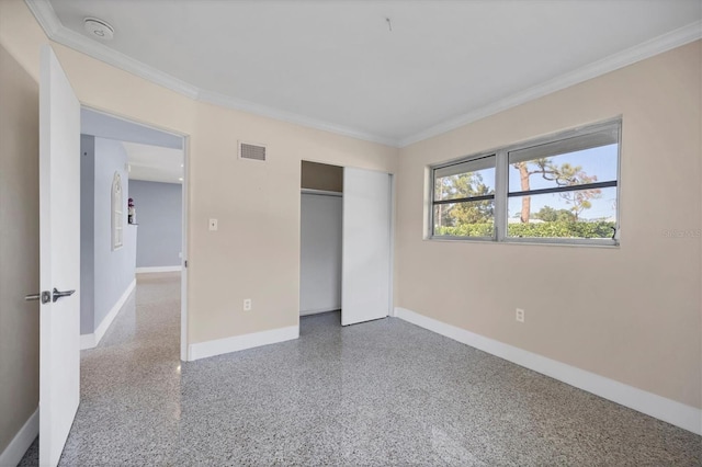 unfurnished bedroom with ornamental molding and a closet