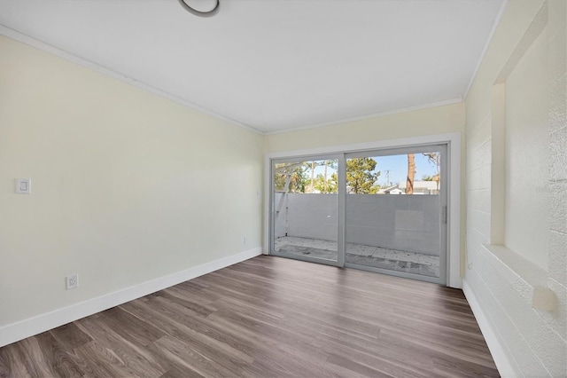 unfurnished room featuring hardwood / wood-style flooring and ornamental molding