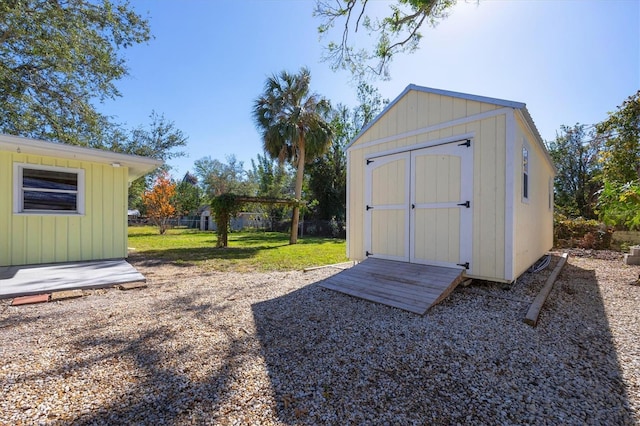 view of outbuilding featuring a lawn