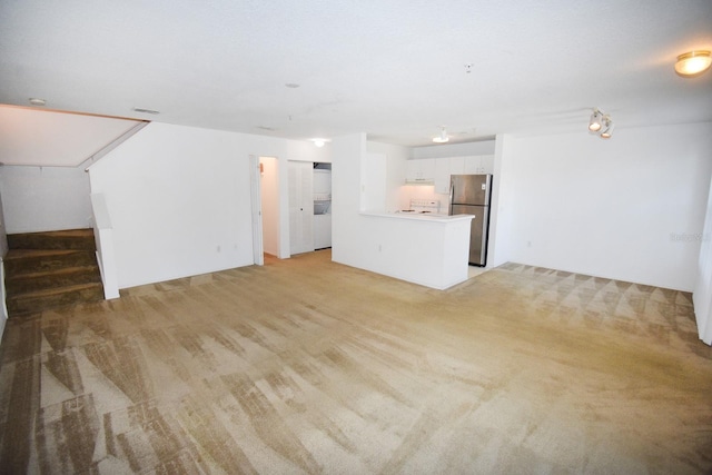 unfurnished living room with light carpet