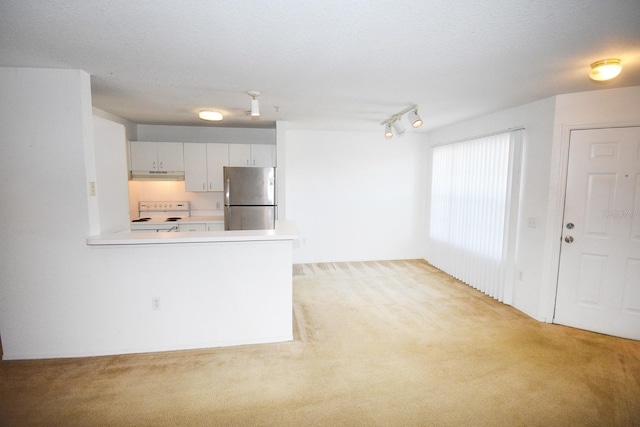 kitchen featuring light carpet, white electric range, stainless steel refrigerator, and kitchen peninsula