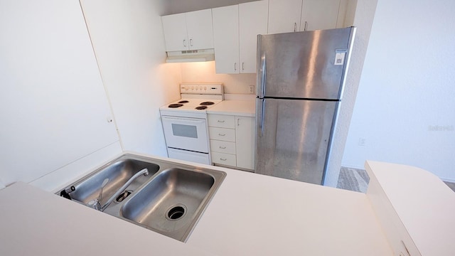 kitchen with white cabinetry, sink, white electric range, and stainless steel refrigerator