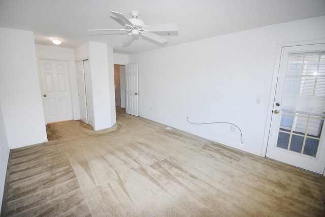 spare room with light carpet and ceiling fan