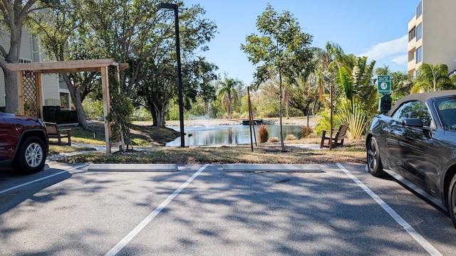 view of parking / parking lot featuring a water view