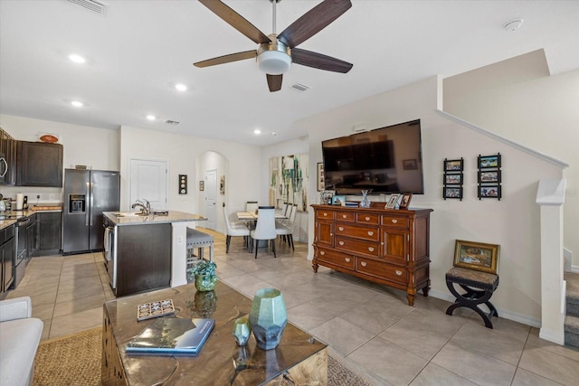 tiled living room with sink and ceiling fan