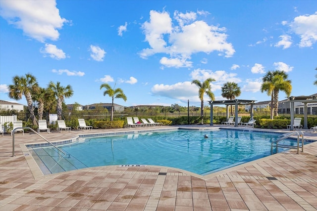 view of pool with a patio and a pergola