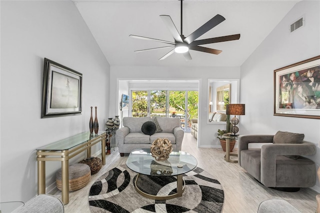 living room with lofted ceiling, ceiling fan, and light wood-type flooring