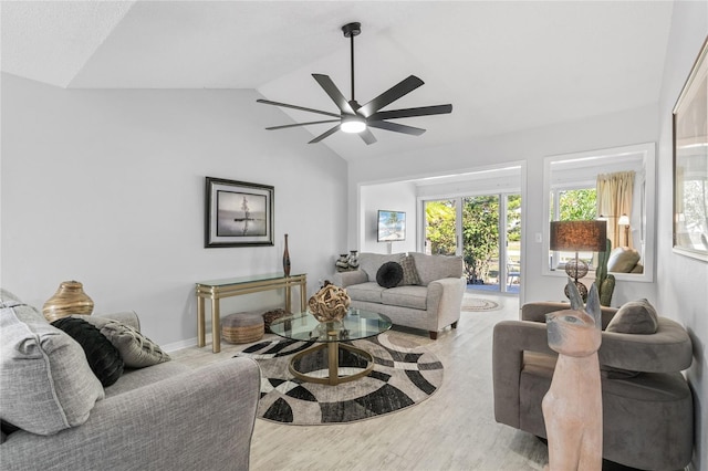 living room with vaulted ceiling, light hardwood / wood-style floors, and ceiling fan