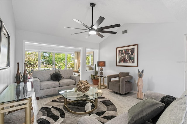 living room with ceiling fan, lofted ceiling, and light hardwood / wood-style floors