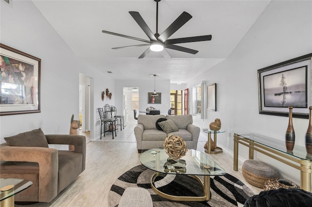 living room featuring ceiling fan and light hardwood / wood-style floors