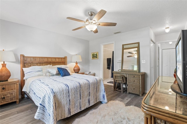 bedroom featuring ceiling fan, dark hardwood / wood-style floors, and a textured ceiling