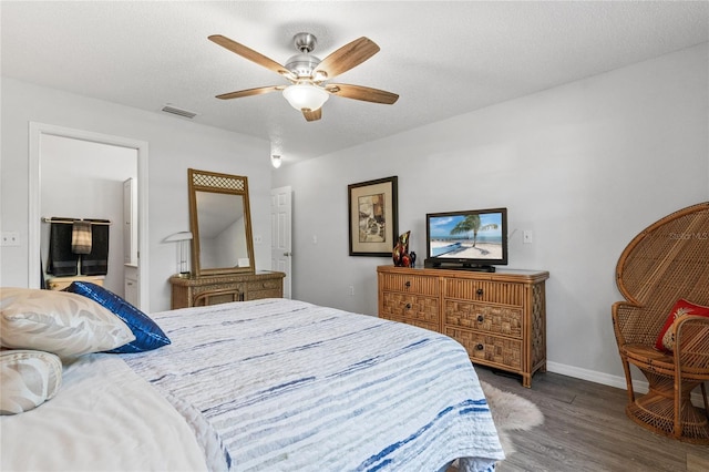 bedroom featuring ceiling fan, wood-type flooring, and a textured ceiling