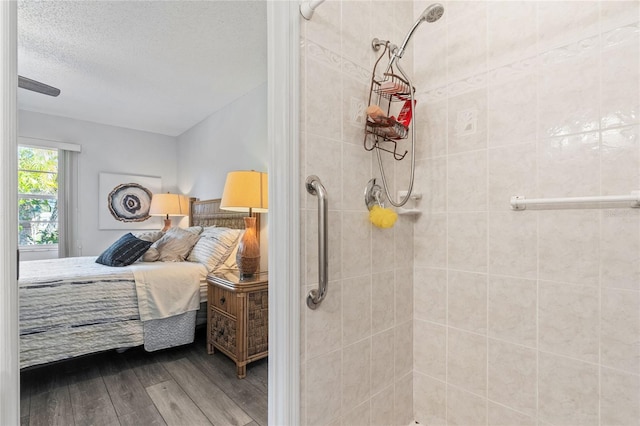 bedroom with hardwood / wood-style floors and a textured ceiling