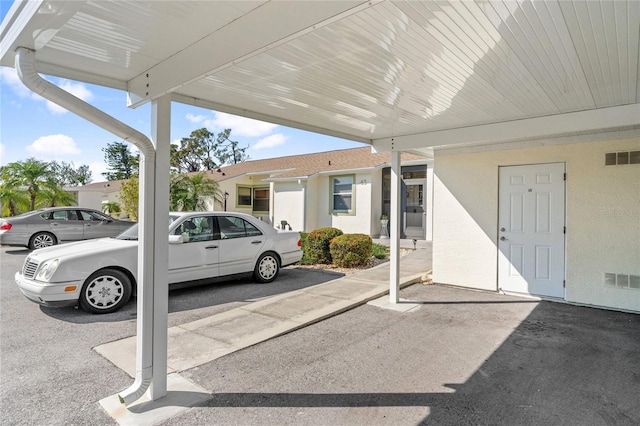 view of parking / parking lot with a carport