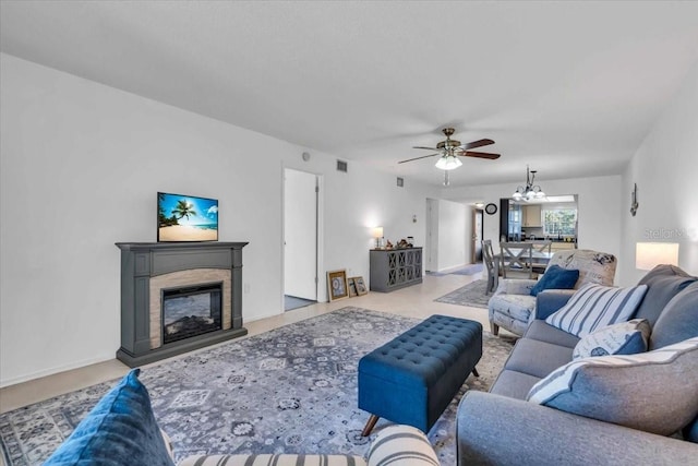 living room featuring ceiling fan with notable chandelier