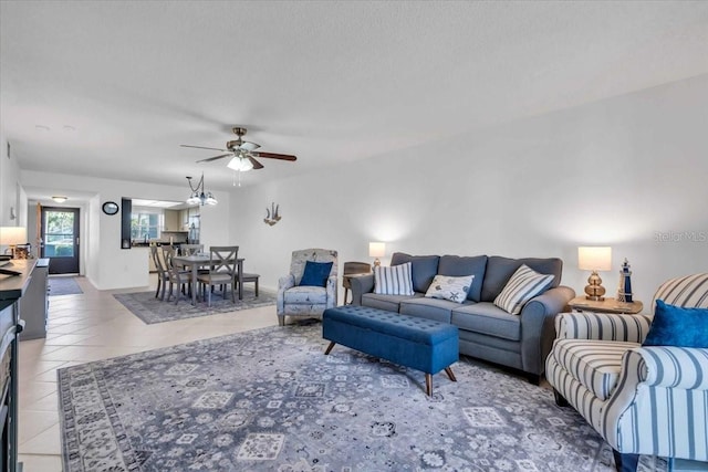 living room with tile patterned flooring, a textured ceiling, and ceiling fan