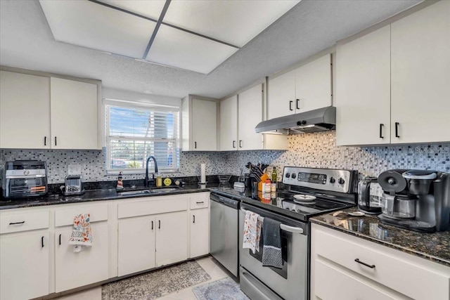 kitchen with white cabinetry, appliances with stainless steel finishes, sink, and backsplash