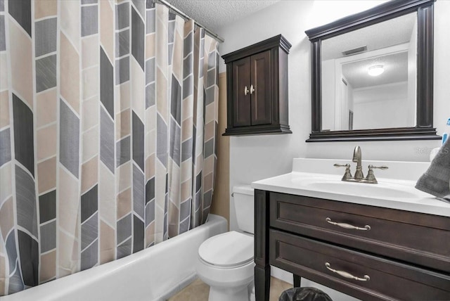 bathroom featuring vanity, toilet, and a textured ceiling