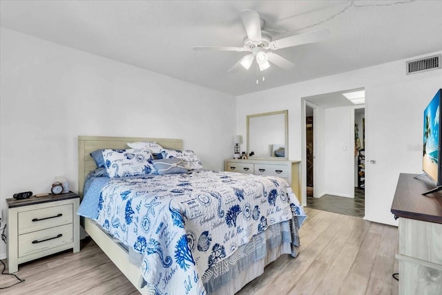 bedroom with ceiling fan and light hardwood / wood-style flooring