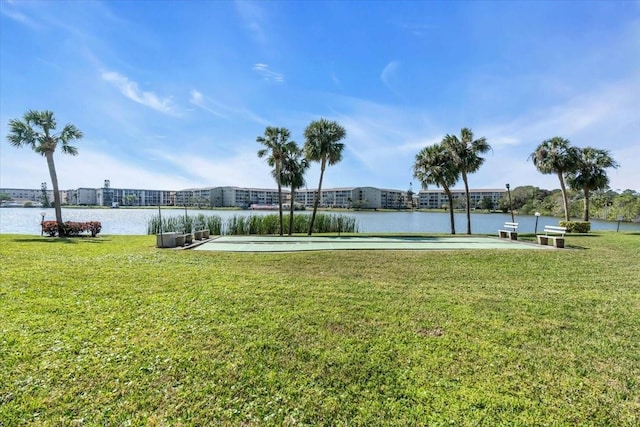 view of community with a yard and a water view