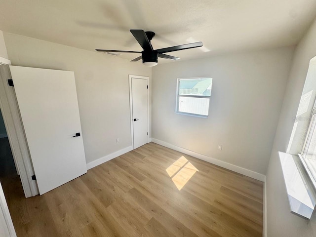 unfurnished bedroom featuring ceiling fan and light wood-type flooring