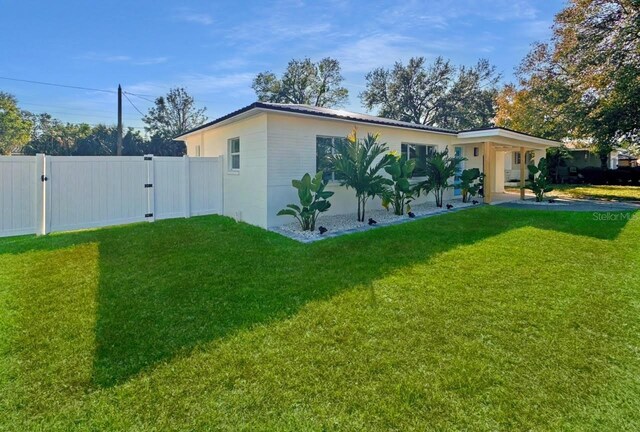 view of side of home with a lawn