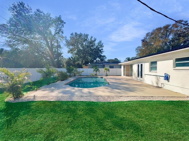 view of pool featuring a yard and a patio