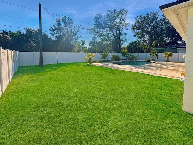 view of yard featuring a fenced in pool and a patio area