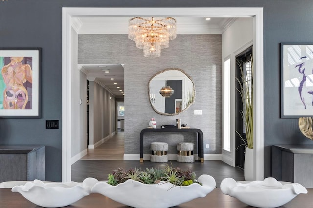 corridor with ornamental molding, dark wood-type flooring, and an inviting chandelier