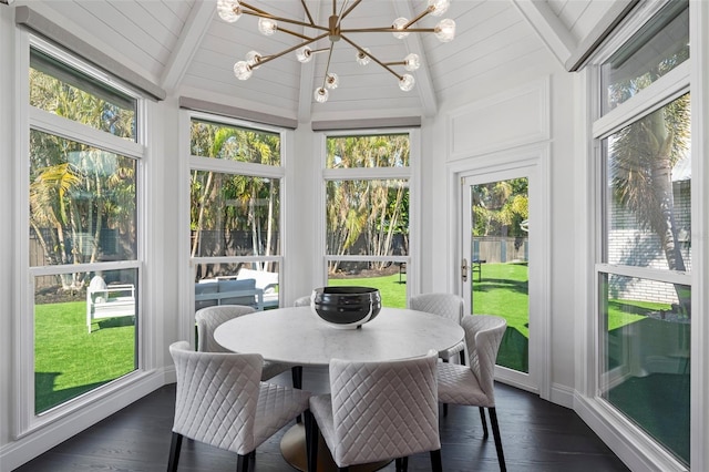 sunroom / solarium featuring vaulted ceiling with beams and a chandelier