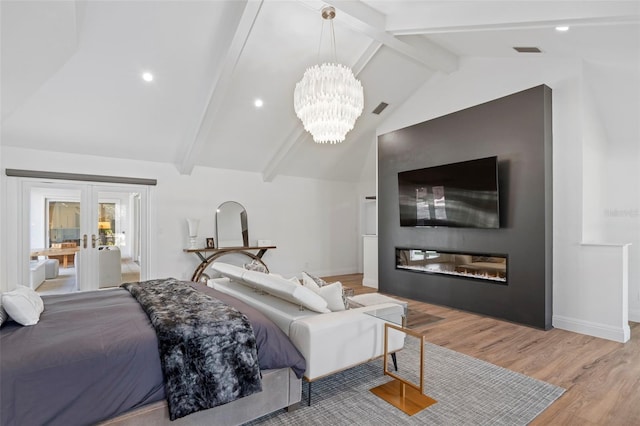 bedroom featuring vaulted ceiling with beams, a notable chandelier, light hardwood / wood-style flooring, and french doors