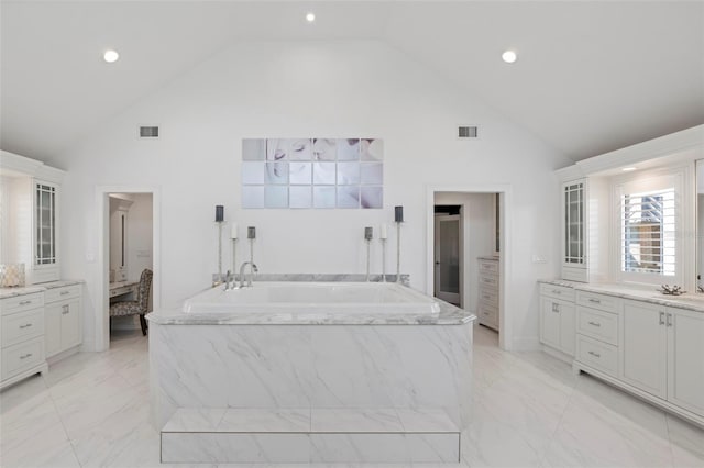 bathroom featuring a tub to relax in, high vaulted ceiling, and vanity