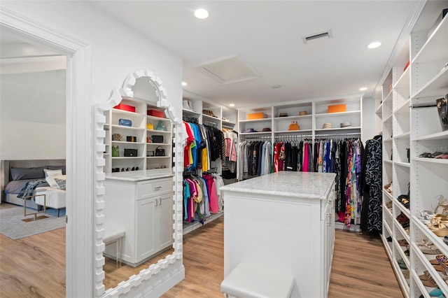 walk in closet featuring light hardwood / wood-style flooring