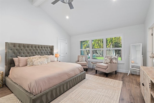 bedroom featuring wood-type flooring, high vaulted ceiling, ceiling fan, and beam ceiling