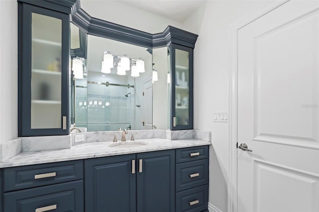 bathroom with vanity and a shower with door